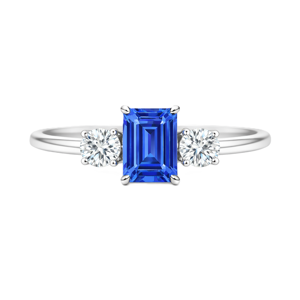 Blue sapphire ring, 6×4 mm emerald cut with 3 mm moissanite sides, set in white gold-plated 925 silver. Elegant and hypoallergenic. Available now at BSI Jewelry.