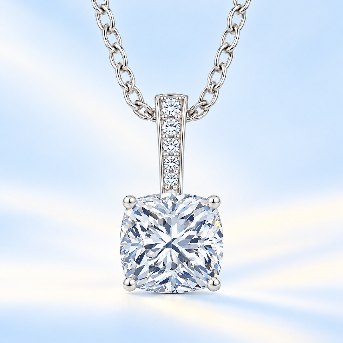 Cushion cut moissanite pendant with 6 mm center stone, round brilliant moissanite bail and white gold-plated 925 silver chain, available at BSI Jewelry