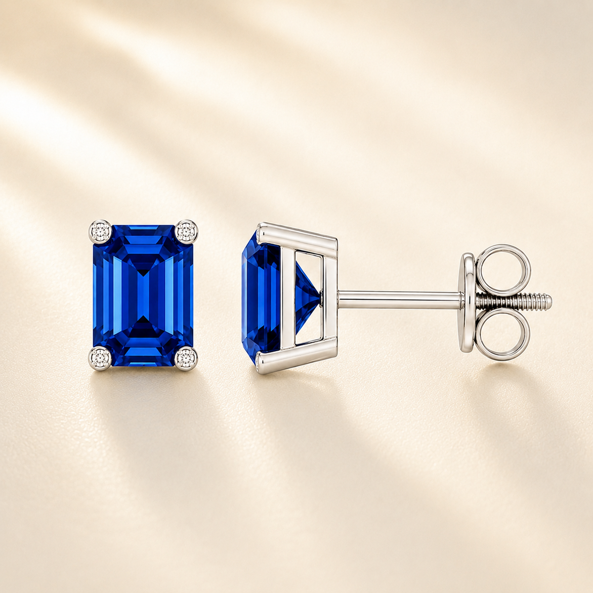 Emerald blue sapphire stud earrings with 6×4 mm stones and moissanite prongs in white gold plated 925 silver. Available now at BSI Jewelry.