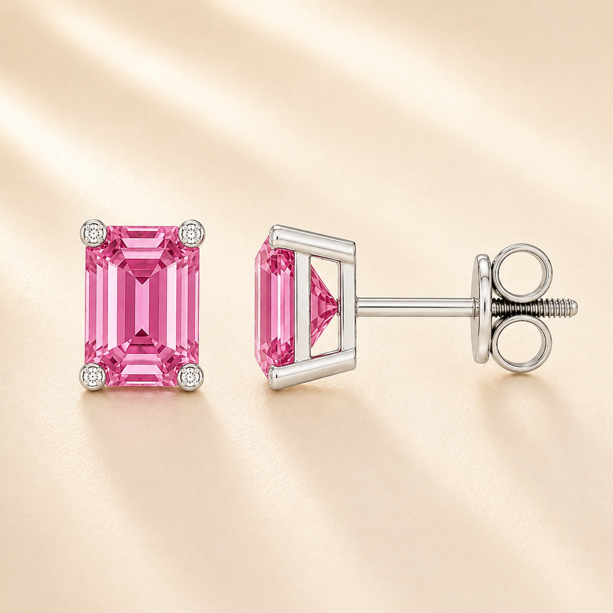 Emerald pink sapphire stud earrings with 6×4 mm stones and moissanite prongs in white gold plated 925 silver. Available now at BSI Jewelry.