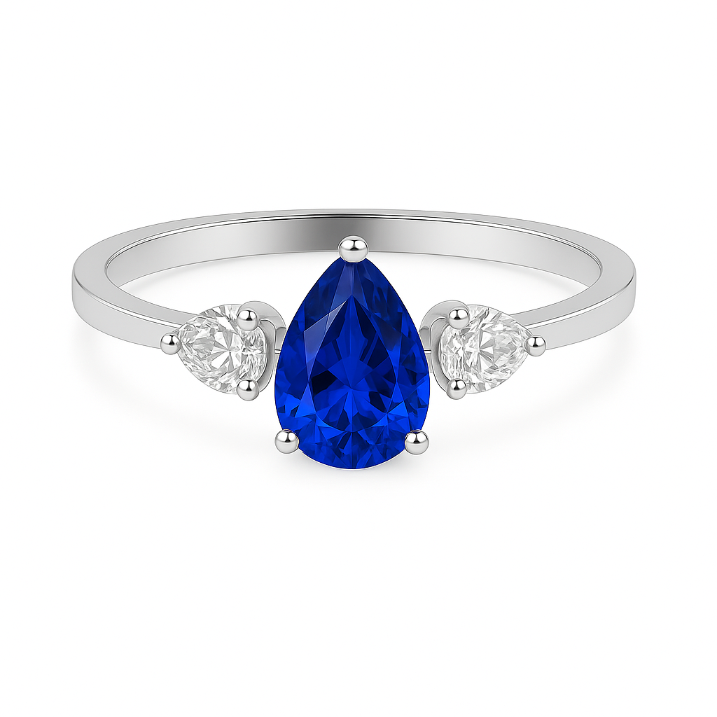 Pear-cut blue sapphire ring with two pear-cut Moissanite side stones in white-gold-plated 925 silver. Timeless elegance and vivid color. Available at BSI Jewelry.