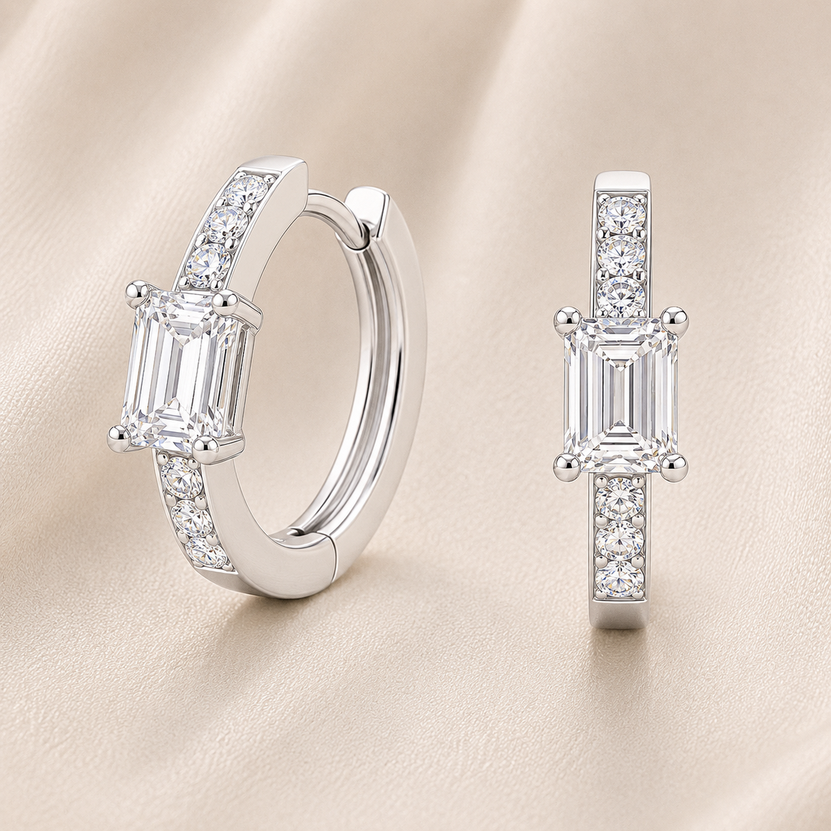 Elegant huggie earrings in white gold-plated 925 silver with a 6×4mm emerald-cut Moissanite for refined brilliance. Available now at BSI Jewelry.