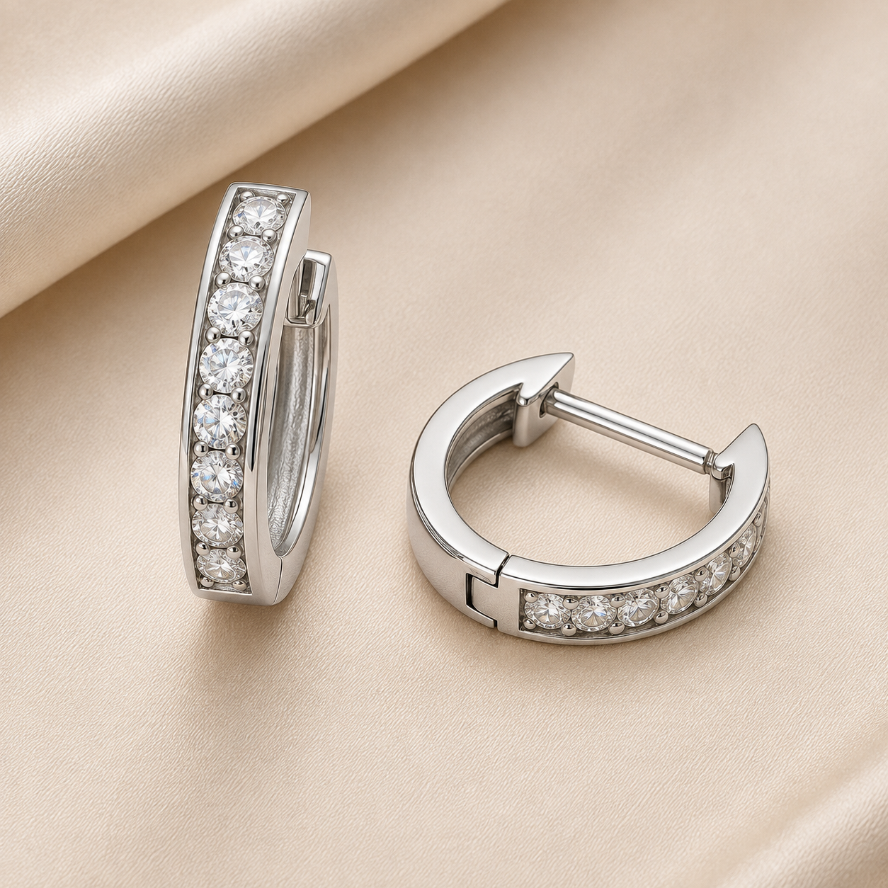 1.5 mm moissanite pave set huggies earrings in white gold-plated 925 silver. Sleek, refined and hypoallergenic for daily wear. Available now at BSI Jewelry.