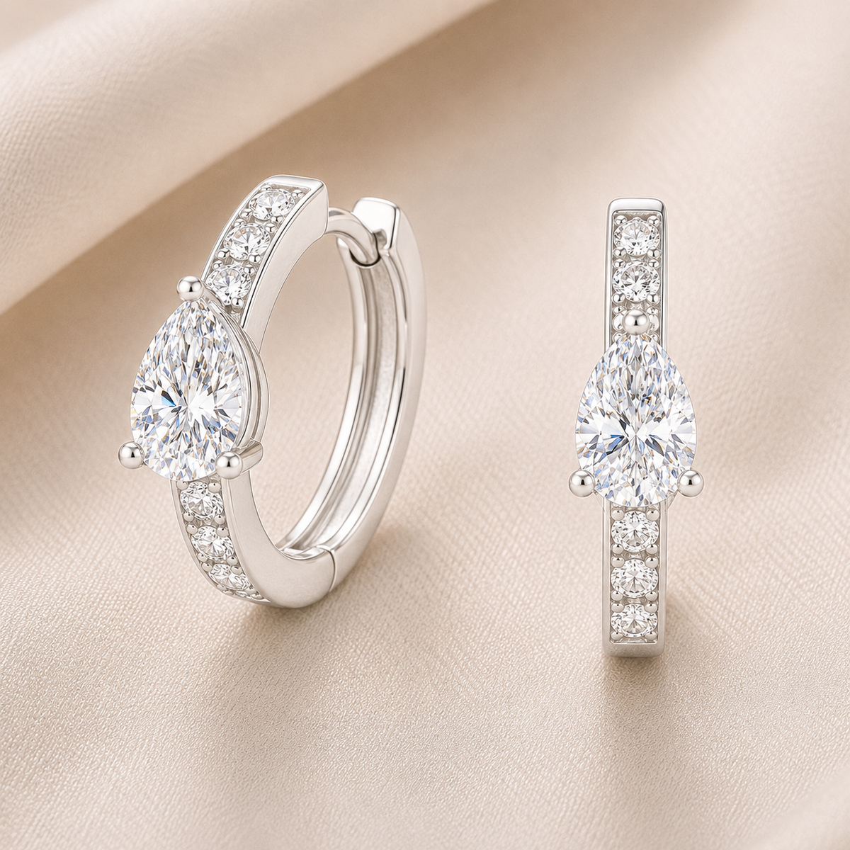 Elegant pear-cut Moissanite huggie earrings in white gold-plated 925 silver, offering timeless brilliance and refined for any occasion. Available at BSI Jewelry.