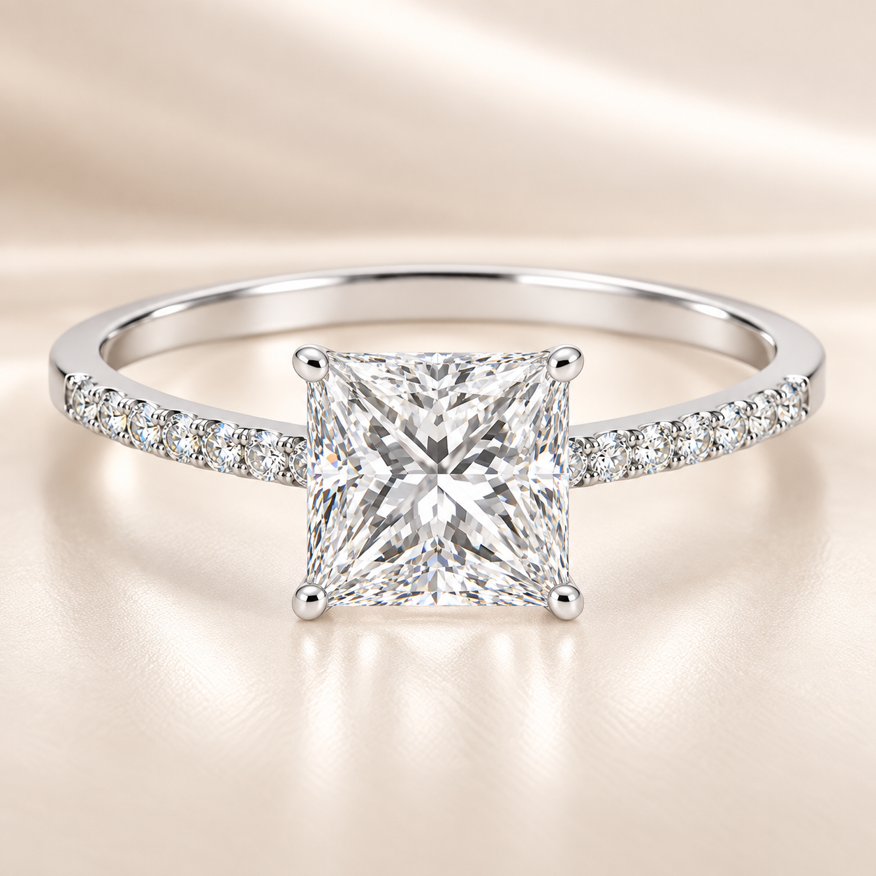 Moissanite princess ring with a 6 mm princess-cut stone, accented by moissanite in white gold-plated 925 silver. Modern and elegant. Available now at BSI Jewelry.