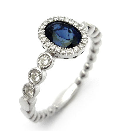 Elegant sapphire halo ring in white gold-plated 925 silver, framed with Moissanite for radiant brilliance. Hypoallergenic and timeless. Available now at BSI Jewelry.