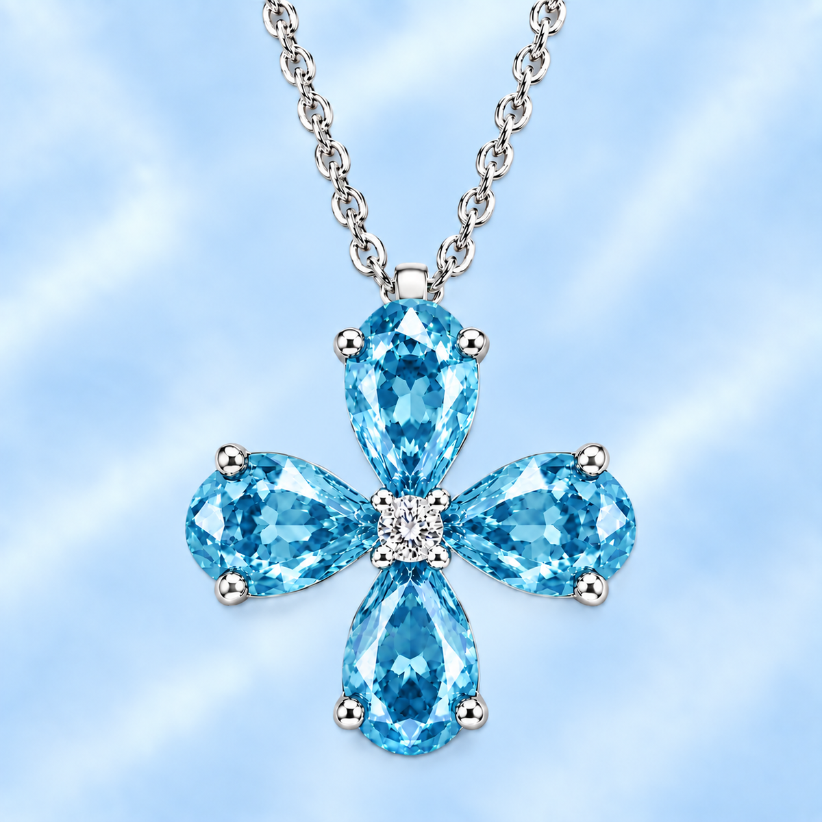 Pear sky blue topaz flower pendant featuring four 5×4 mm pear gemstones in white gold-plated 925 silver with moissanite accent and available now at BSI Jewelry.