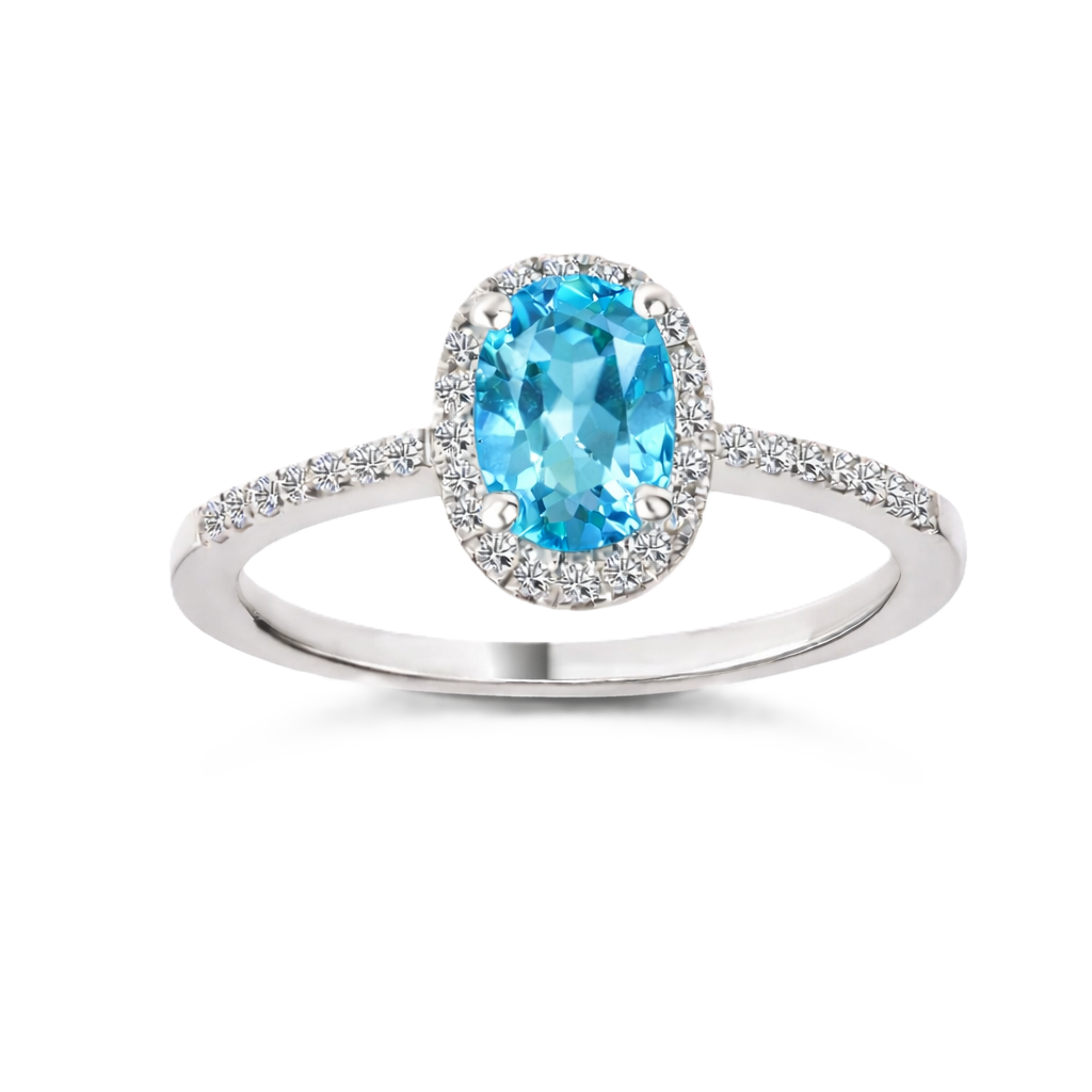 Sky blue topaz ring with a 7×5 mm oval-cut stone, accented by moissanite in white gold-plated 925 silver. Fresh and elegant. Available now at BSI Jewelry.