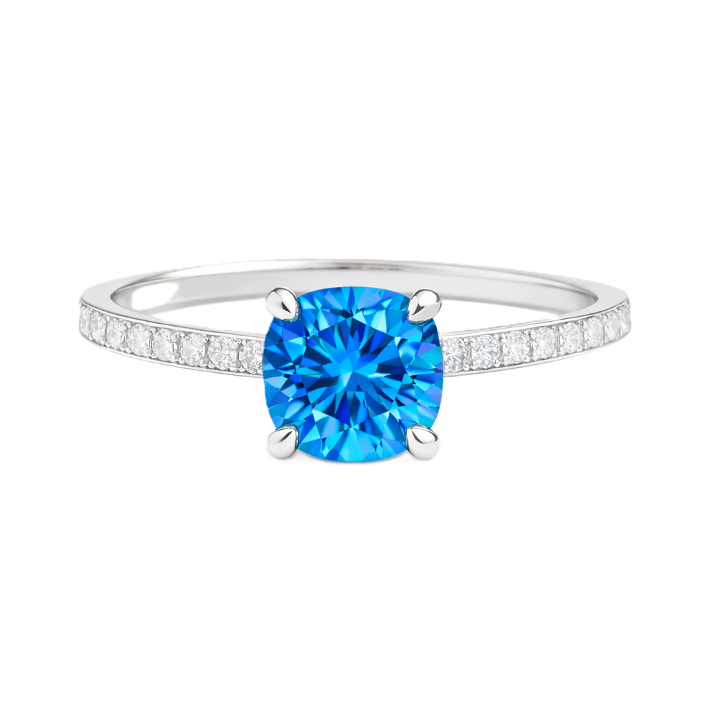 Swiss blue topaz ring with a 6 mm cushion in white gold-plated 925 silver, accented with moissanite. Fresh and elegant for daily wear. Available now at BSI Jewelry.