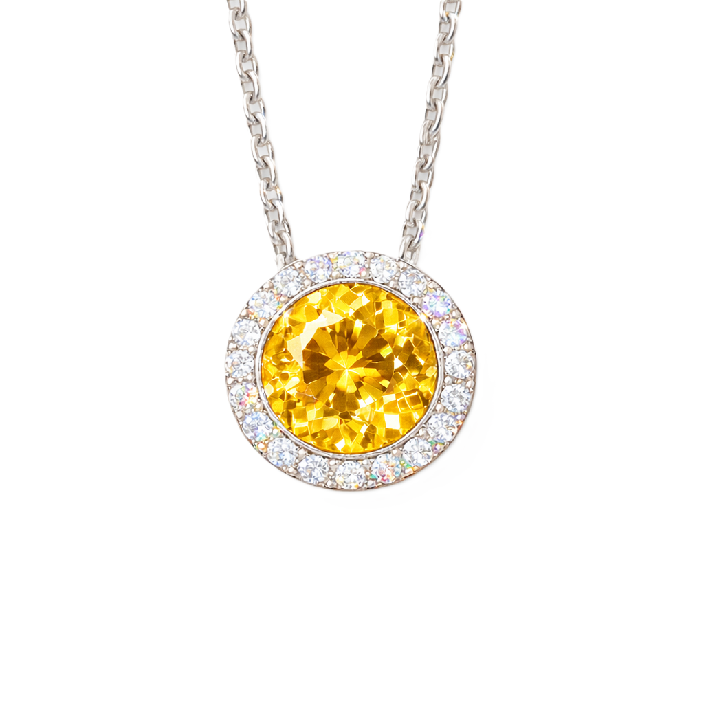 Yellow sapphire pendant with 6 mm round stone in white gold-plated 925 silver, accented with moissanite and adjustable cable chain. Available now at BSI Jewelry.