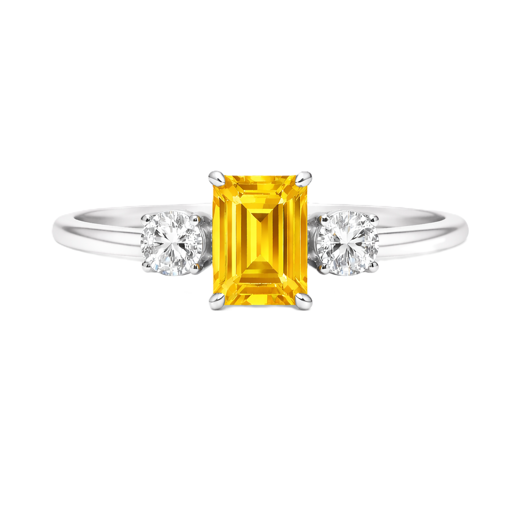 Yellow sapphire ring, 6×4 mm emerald cut with 3 mm moissanite sides, set in white gold-plated 925 silver. Elegant and hypoallergenic. Available now at BSI Jewelry.