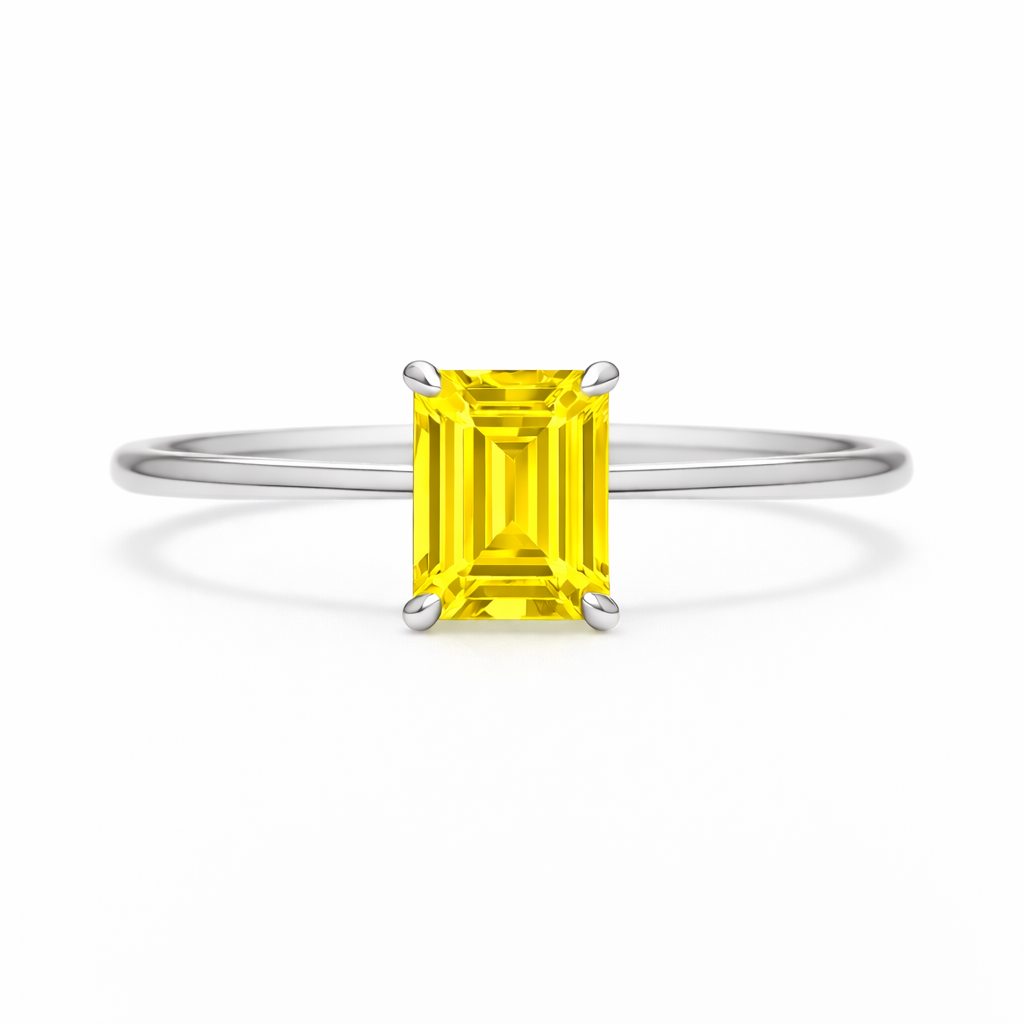 Elegant 6×4 mm emerald-cut yellow sapphire ring crafted in white gold-plated 925 silver with palladium alloy. Timeless brilliance. Available now at BSI Jewelry.