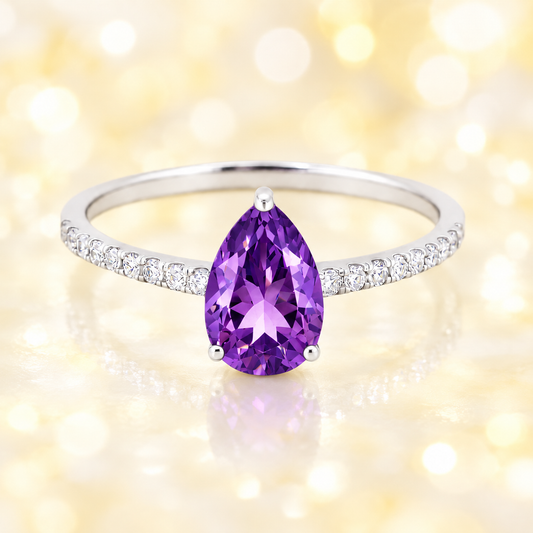 Amethyst ring with a 7×5 mm pear-cut stone and moissanite accents in white gold plated 925 silver. Elegant for daily wear. Available now at BSI Jewelry.