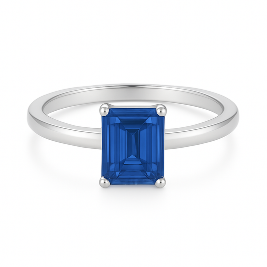 7×5 mm emerald-cut blue sapphire solitaire ring set in white-gold-plated 925 silver. Radiant color, refined simplicity, and timeless elegance. Now at BSI Jewelry.