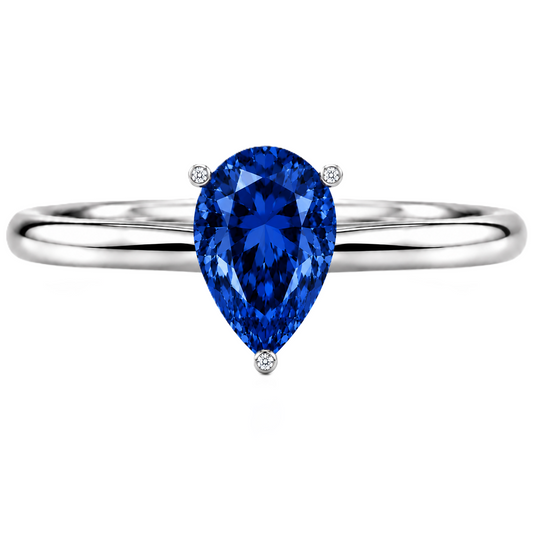 Royal blue sapphire engagement ring with a 6×4 mm pear-cut center stone, crafted in white gold plated 925 silver. Available now at BSI Jewelry.