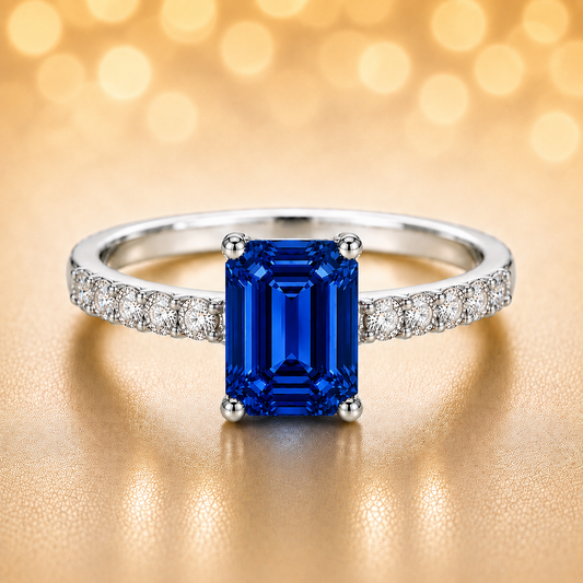 7×5mm emerald-cut Blue Sapphire ring with Moissanite accents in white-gold-plated 925 silver. Elegant, radiant, and hypoallergenic. Available at BSI Jewelry.
