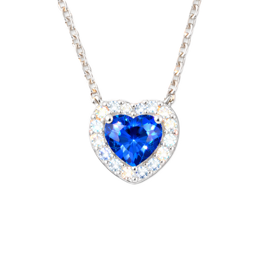 Blue sapphire heart pendant with 6 mm center stone in white gold-plated 925 silver. Elegant and timeless for daily wear. Available now at BSI Jewelry.
