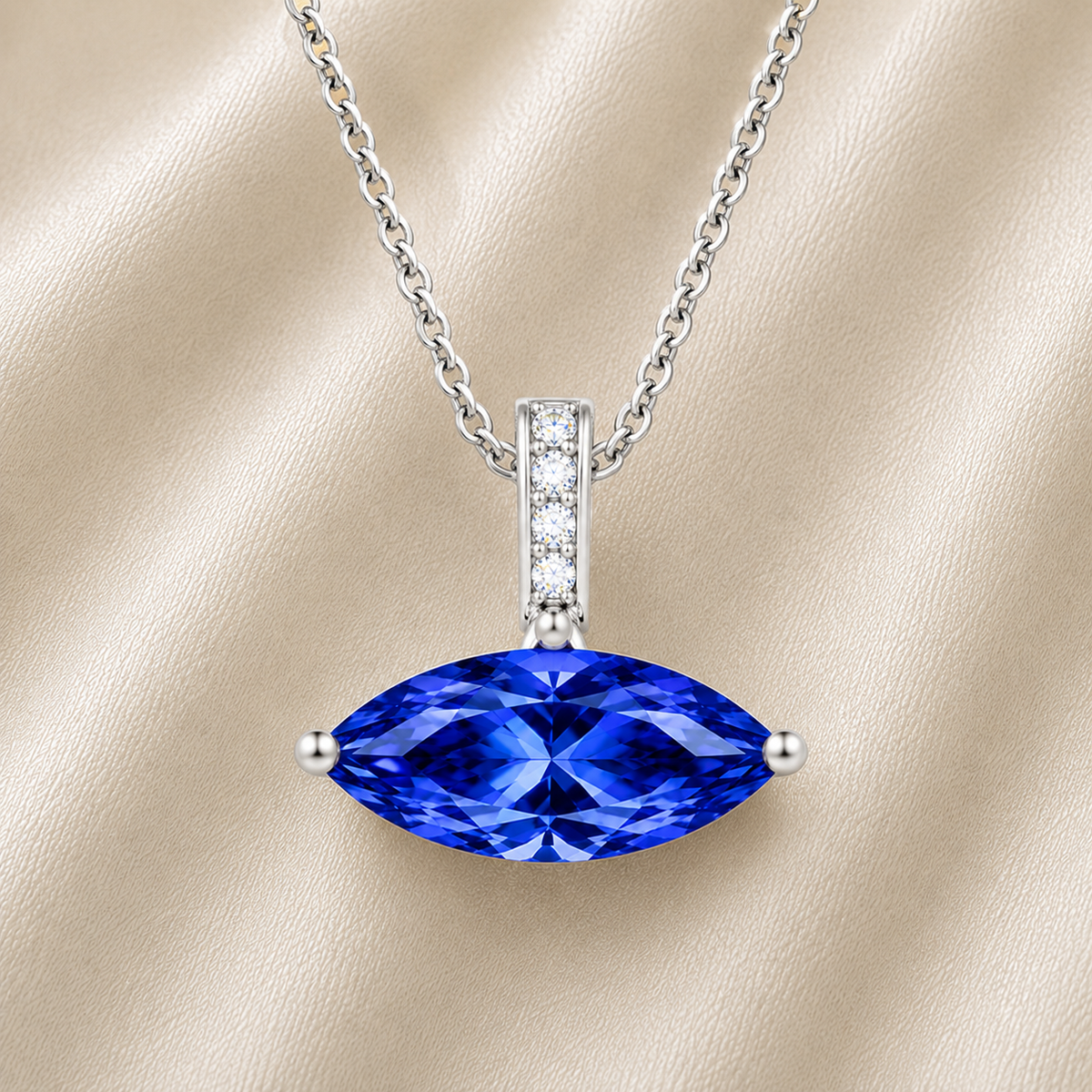Blue sapphire marquise pendant with an 8×5 mm gemstone in white gold-plated 925 silver with moissanite accents. Elegant and refined. Available now at BSI Jewelry.