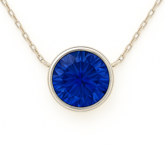 Elegant blue sapphire necklace with a 5mm round brilliant-cut stone in white gold-plated 925 silver. Timeless and radiant. Available now at BSI Jewelry.
