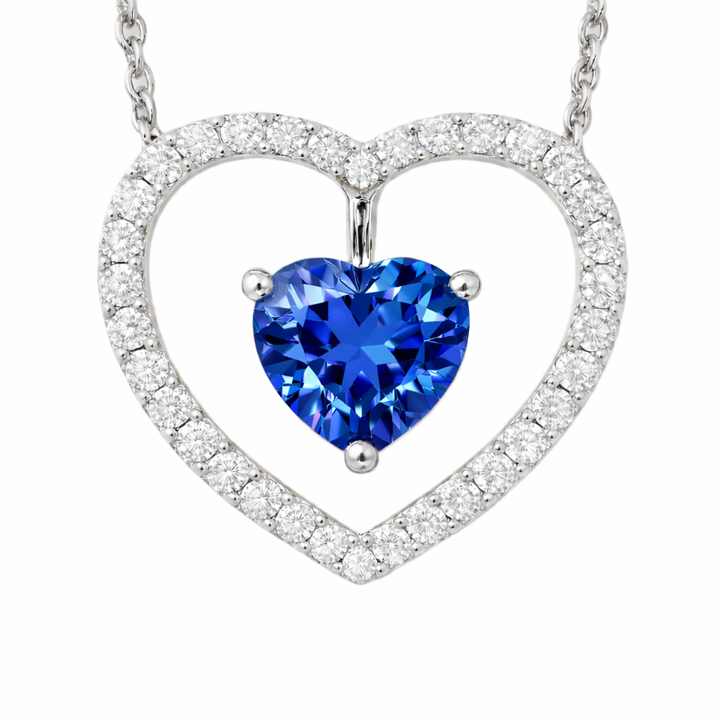 Blue sapphire necklace with a 6 mm heart cut and moissanite halo, crafted in white gold-plated 925 silver. Elegant and romantic. Available now at BSI Jewelry.
