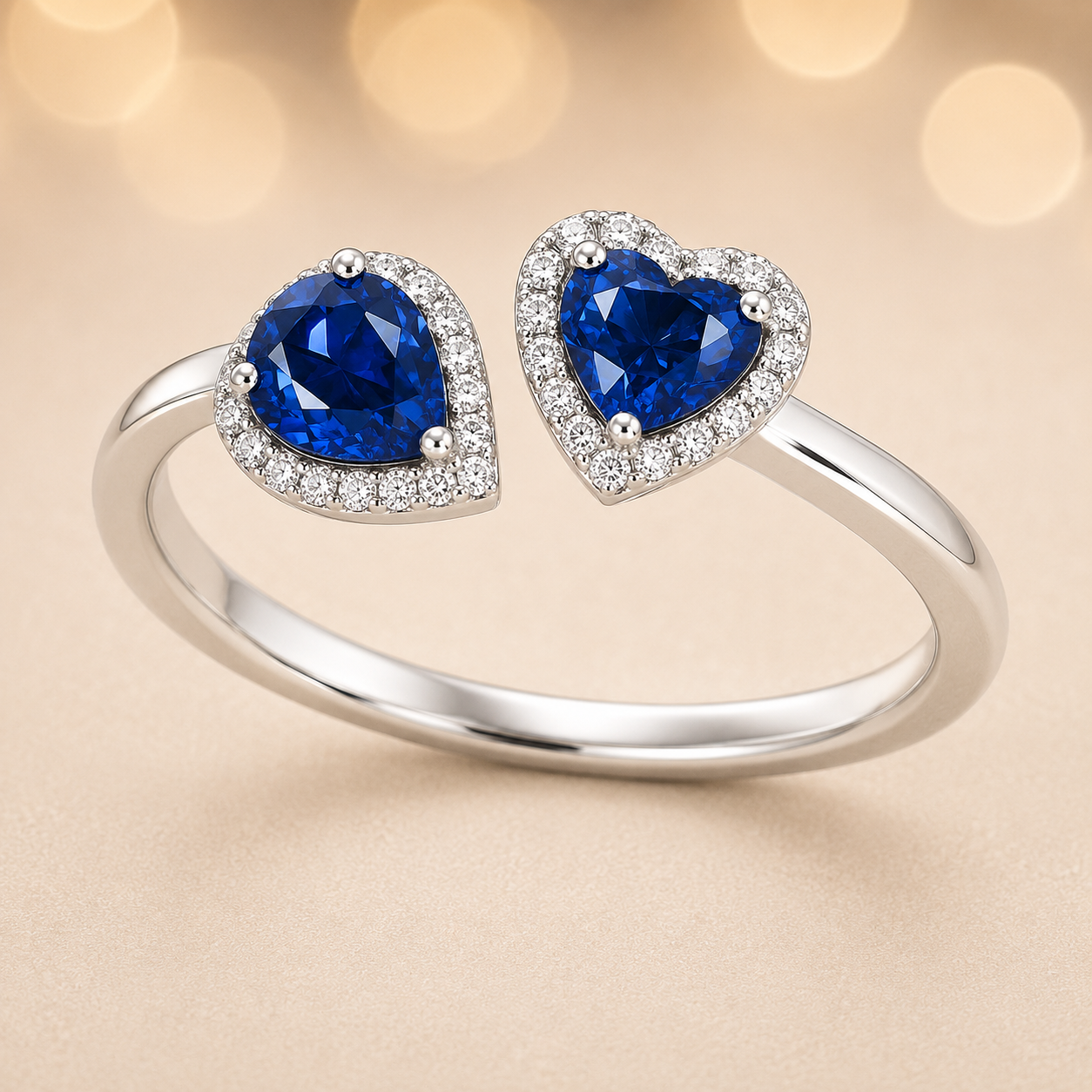 Blue sapphire open ring with 6×4 mm pear and 5 mm heart cuts, crafted in white gold-plated 925 silver. Hypoallergenic elegance. Available now at BSI Jewelry.