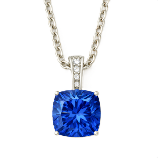 Blue sapphire pendant with a 6 mm cushion gemstone in white gold-plated 925 silver, accented with moissanite. Elegant and refined. Available now at BSI Jewelry.