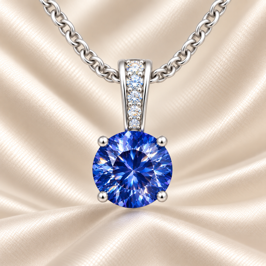 Blue sapphire pendant with a 6 mm round cut, set in white gold-plated 925 silver. Elegant, timeless, and refined for daily wear. Available now at BSI Jewelry.