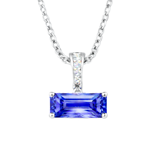 Blue sapphire pendant with an 8×5 mm baguette in white gold-plated 925 silver, accented with moissanite. Elegant and refined. Available now at BSI Jewelry.