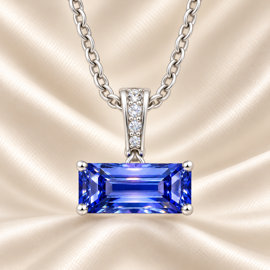 Blue sapphire pendant with an 8×5 mm baguette in white gold-plated 925 silver, accented with moissanite. Elegant and refined. Available now at BSI Jewelry.