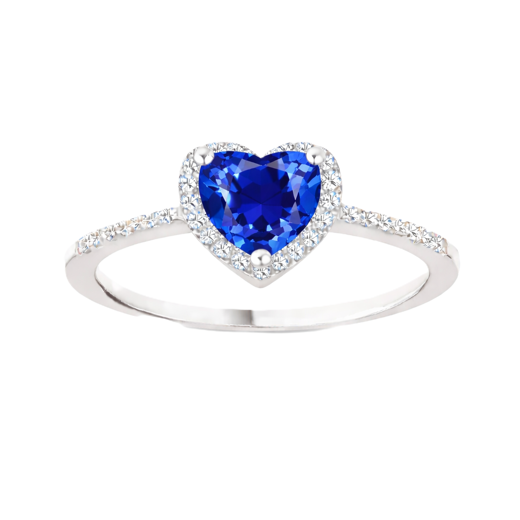 Blue sapphire ring with a 6 mm heart cut, accented by moissanite in white gold-plated 925 silver. Elegant and timeless. Available now at BSI Jewelry.
