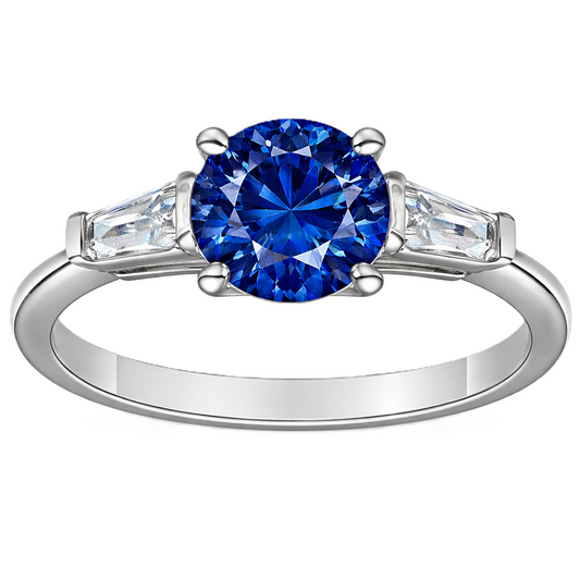 Blue sapphire ring, 6 mm round, with tapered moissanite accents in white gold-plated 925 silver. Elegant and timeless. Available now at BSI Jewelry.