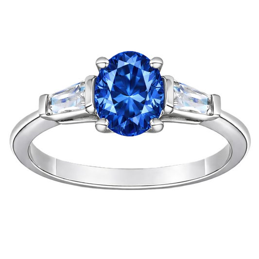 Blue sapphire ring with 7×5 mm oval center in white gold-plated 925 silver. Classic, elegant, and hypoallergenic. Available now at BSI Jewelry.