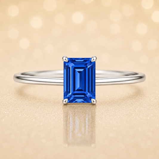 Elegant 6×4 mm emerald-cut blue sapphire ring crafted in white gold-plated 925 silver with palladium alloy. Timeless brilliance. Available now at BSI Jewelry.
