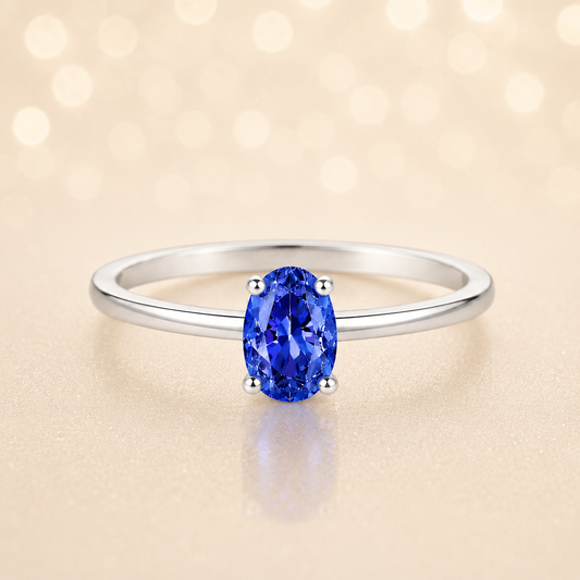 Blue sapphire solitaire ring with a 6×4 mm oval in white gold-plated 925 silver. Elegant, minimal, and timeless for daily wear. Available now at BSI Jewelry.