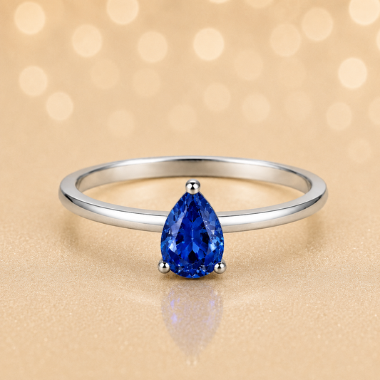 Blue sapphire solitaire ring with a 6×4 mm pear in white gold-plated 925 silver. Elegant, minimal, and timeless for daily wear. Available now at BSI Jewelry.
