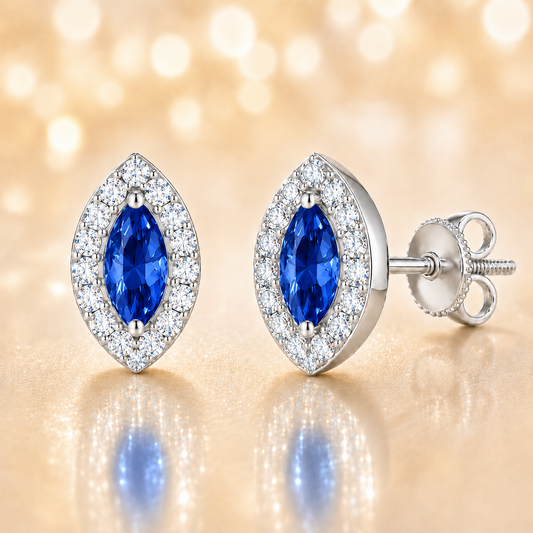Blue sapphire stud earrings with 5×2.5 mm marquise in white gold-plated 925 silver, accented with moissanite. Elegant and timeless. Available now at BSI Jewelry.