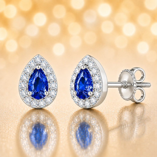 Blue sapphire stud earrings with 5×3 mm pear in white gold-plated 925 silver, accented with moissanite and secure screw-back posts. Available now at BSI Jewelry.