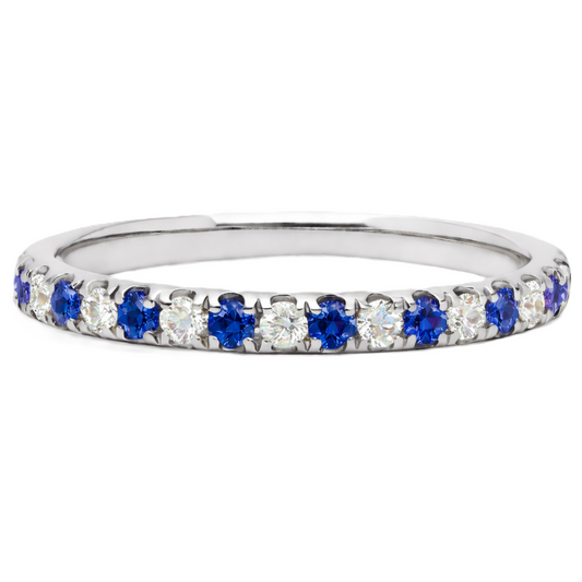 Blue sapphire wedding band with 1.80 mm round-cut stones, crafted in white gold-plated 925 silver and accented with moissanite. Available now at BSI Jewelry.