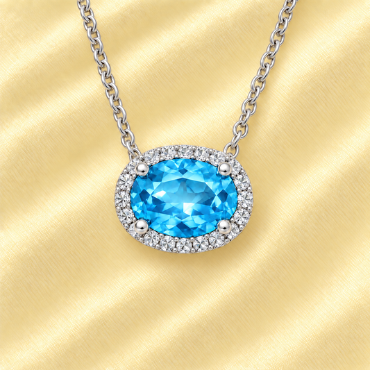 Elegant Oval Blue Topaz Necklace featuring a 9x7 mm gemstone with round brilliant Moissanite in white gold plated 925 silver. Hypoallergenic. Shop BSI Jewelry.