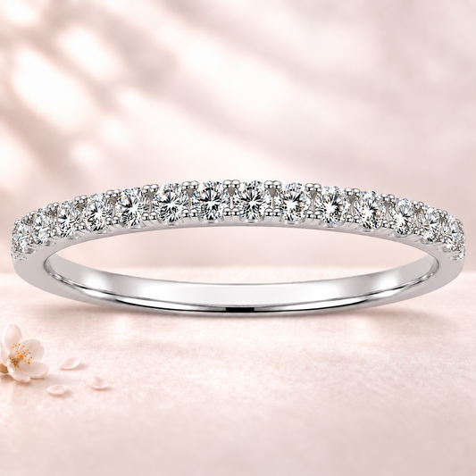 Round moissanite wedding band crafted in white gold-plated 925 silver. Elegant brilliance and timeless sparkle for everyday wear. Available now at BSI Jewelry.