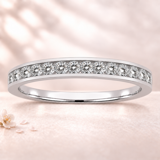 Round moissanite wedding band crafted in white gold-plated 925 silver. Elegant brilliance and timeless sparkle for everyday wear. Available now at BSI Jewelry.