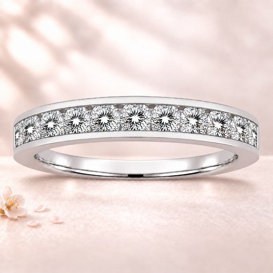 Round moissanite wedding band crafted in white gold-plated 925 silver. Elegant brilliance and timeless sparkle for everyday wear. Available now at BSI Jewelry.