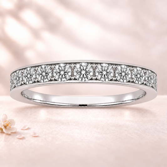 Round moissanite wedding band crafted in white gold-plated 925 silver. Elegant brilliance and timeless sparkle for everyday wear. Available now at BSI Jewelry.