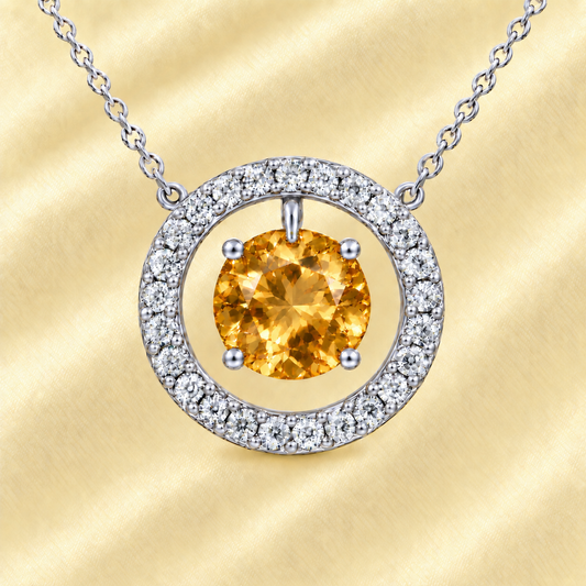 Citrine necklace with a 6 mm round gemstone and moissanite halo in white gold-plated 925 silver. Elegant and radiant. Available now at BSI Jewelry.