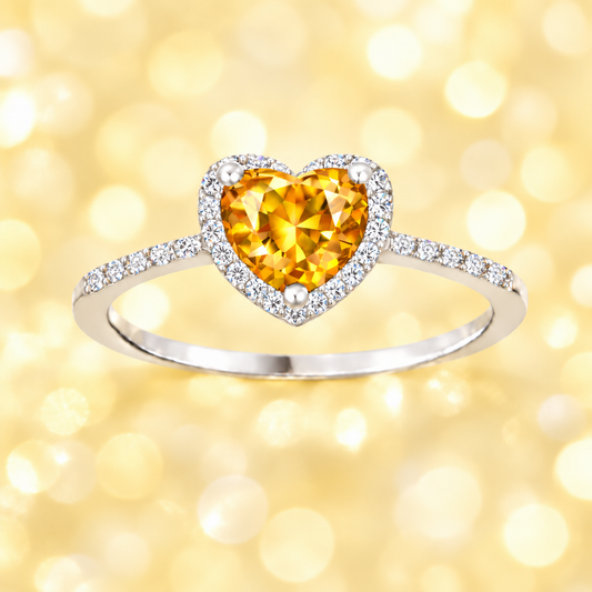 Citrine ring with a 6 mm heart cut, crafted in white gold-plated 925 silver and accented with moissanite. Available now at BSI Jewelry.