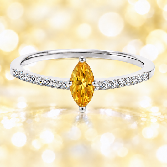 Citrine ring with an 8×4 mm marquise-cut stone, accented by moissanite in white gold-plated 925 silver. Warm and elegant. Available now at BSI Jewelry.