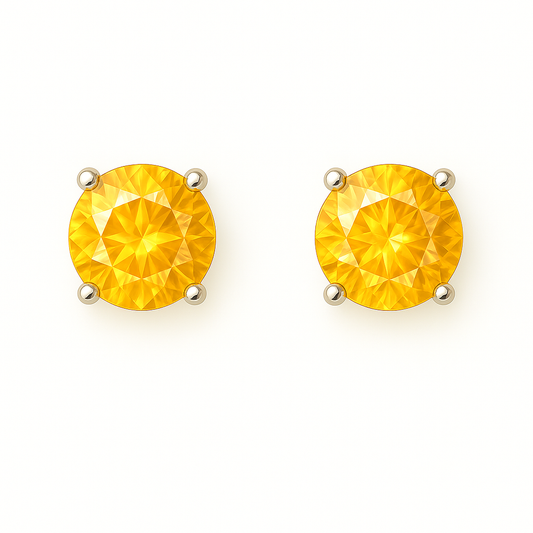 Citrine stud earrings with 4 mm round cut, crafted in white gold-plated 925 silver and palladium alloy. Radiant golden sparkle. Available now at BSI Jewelry.