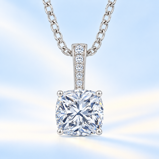 Cushion cut moissanite pendant with 6 mm center stone, round brilliant moissanite bail and white gold-plated 925 silver chain, available at BSI Jewelry
