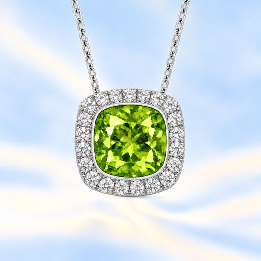 Peridot cushion pendant, 6 mm cushion center with halo, crafted in white gold-plated 925 silver. Bright, fresh, and elegant. Available now at BSI Jewelry.