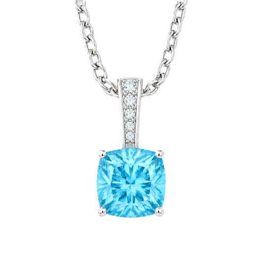 Swiss blue topaz cushion pendant in white gold-plated 925 silver with moissanite accents. Elegant and hypoallergenic. Available now at BSI Jewelry.